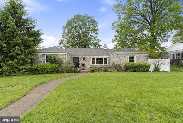 ranch-style house featuring stone siding, a chimney, and a front lawn