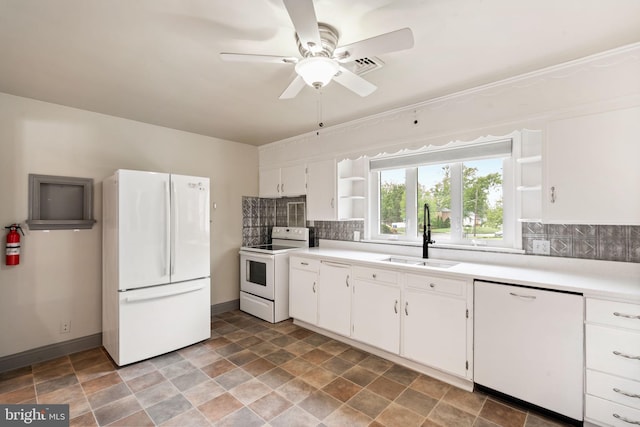 kitchen with white appliances, open shelves, a sink, decorative backsplash, and stone finish flooring