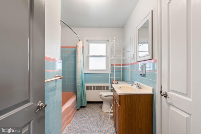 full bathroom featuring radiator, tile walls, toilet, vanity, and shower / bathtub combination with curtain