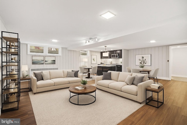 living room featuring dark wood finished floors and baseboards