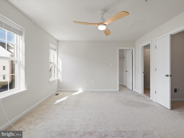 unfurnished bedroom featuring baseboards, visible vents, and carpet flooring