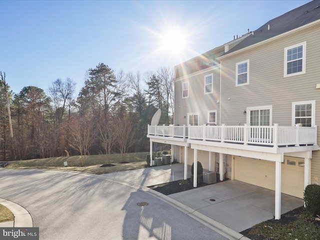 rear view of house featuring driveway and an attached garage