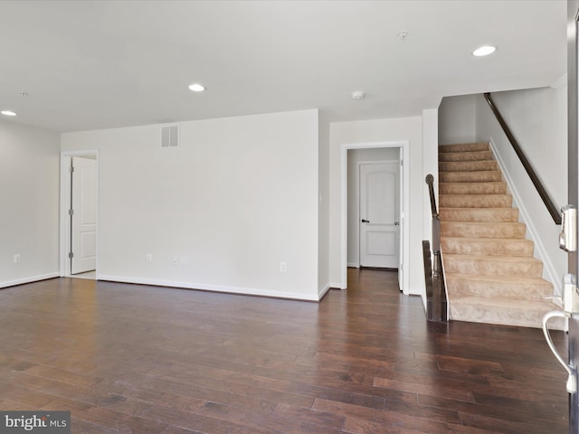 unfurnished living room with recessed lighting, visible vents, stairway, and wood finished floors