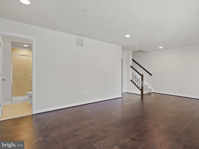 spare room with recessed lighting, wood-type flooring, visible vents, baseboards, and stairs