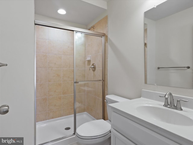 full bathroom with toilet, a stall shower, and vanity