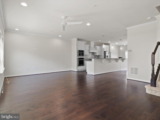 unfurnished living room featuring stairs, visible vents, dark wood-style flooring, and recessed lighting