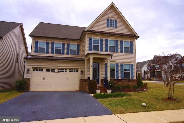 view of front of house featuring driveway, a standing seam roof, metal roof, a front yard, and a garage