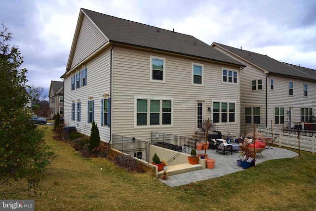 back of property with a patio and a yard