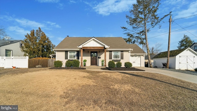 view of front of house featuring an attached garage, a shingled roof, fence, concrete driveway, and a front yard