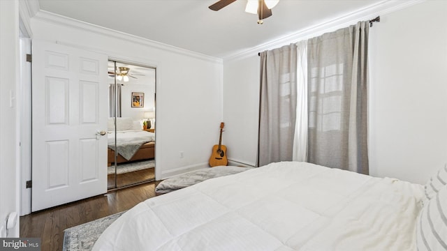 bedroom featuring ornamental molding, a closet, ceiling fan, and wood finished floors