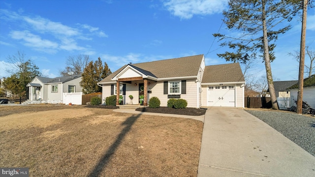 view of front of house featuring driveway, roof with shingles, an attached garage, and fence