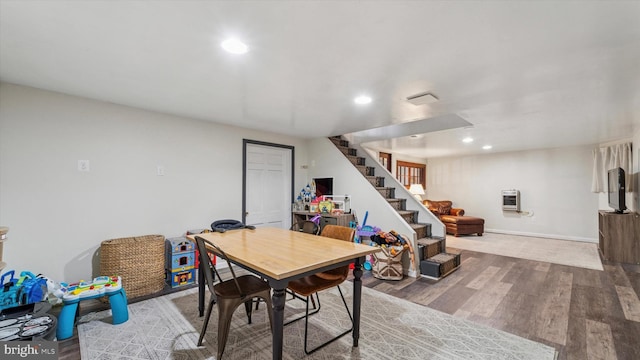 interior space with baseboards, wood finished floors, heating unit, stairs, and recessed lighting