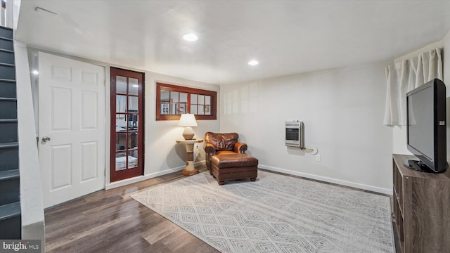 sitting room featuring heating unit, baseboards, wood finished floors, and recessed lighting