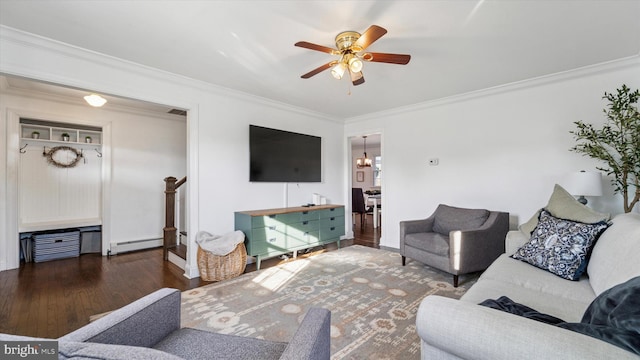 living area with visible vents, ornamental molding, baseboard heating, and wood finished floors