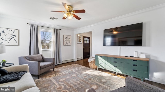 living room featuring visible vents, baseboard heating, crown molding, and wood finished floors