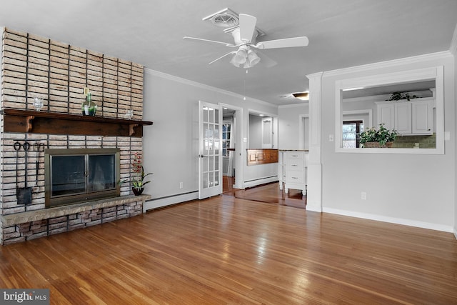 unfurnished living room featuring a baseboard radiator, crown molding, and wood finished floors