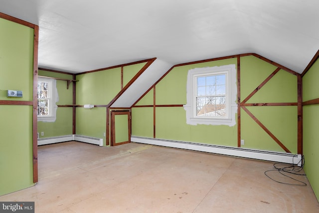 bonus room with plenty of natural light, vaulted ceiling, and baseboard heating