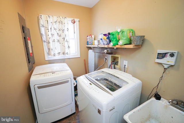 laundry area with washing machine and dryer, laundry area, and a sink