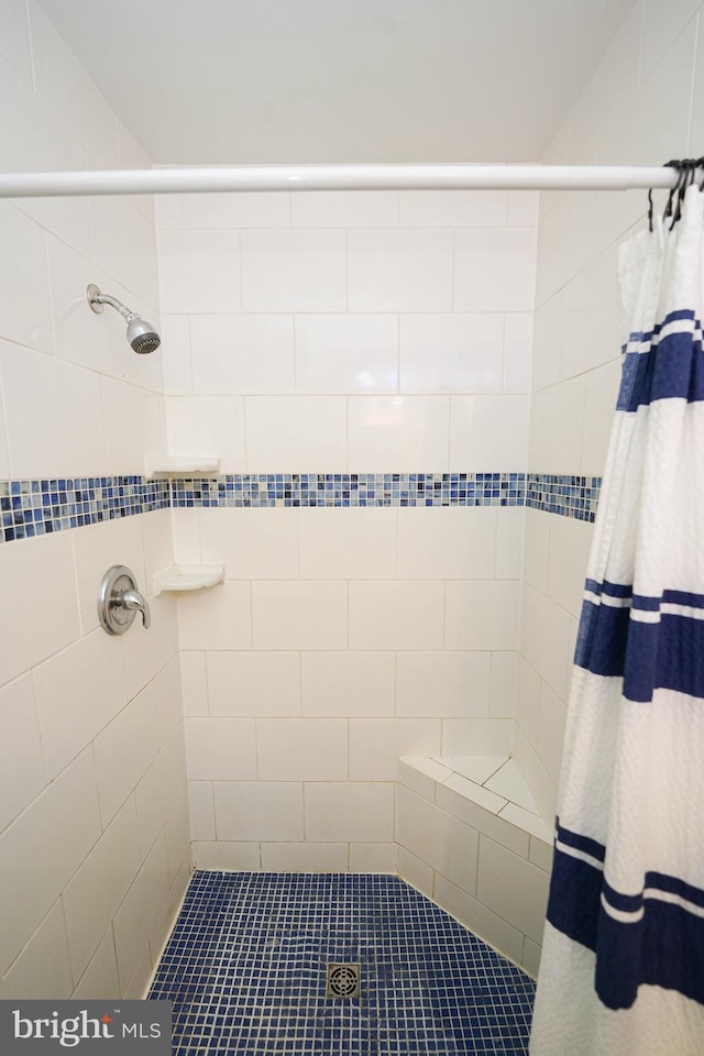 bathroom with tiled shower