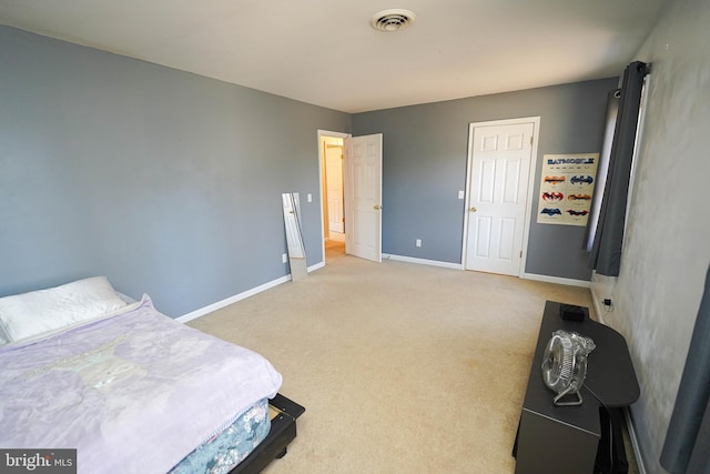 bedroom with baseboards, visible vents, and light colored carpet