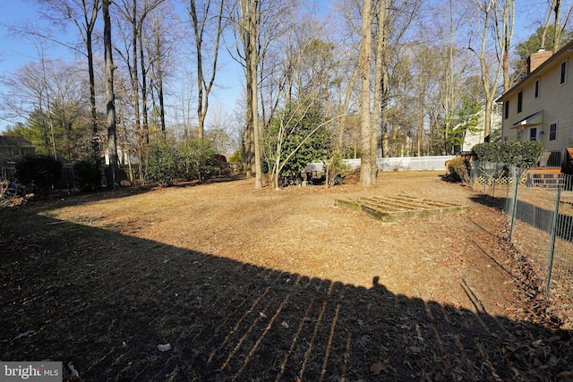 view of yard featuring a vegetable garden and fence