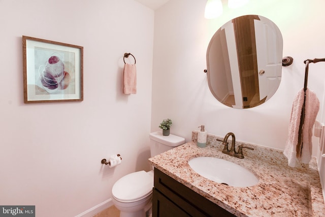 bathroom with toilet and vanity