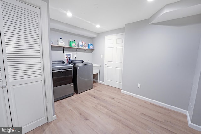 washroom featuring baseboards, laundry area, recessed lighting, separate washer and dryer, and light wood-style floors