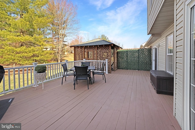 wooden deck featuring outdoor dining space