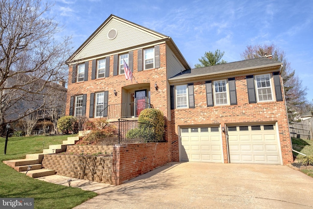 view of front facade with brick siding, a front yard, an attached garage, and driveway