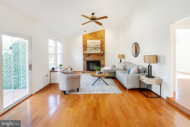 living room with lofted ceiling, light wood-style flooring, plenty of natural light, and ceiling fan