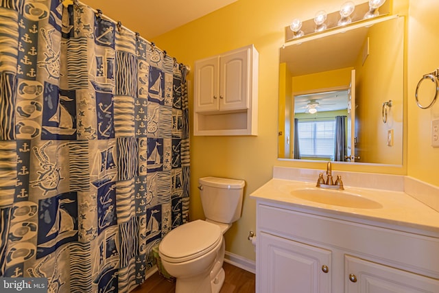 bathroom featuring vanity, wood finished floors, baseboards, ceiling fan, and toilet