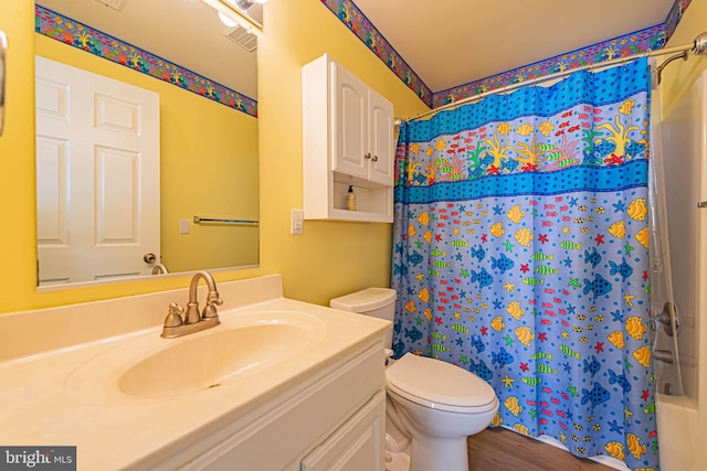 bathroom featuring shower / tub combo, toilet, wood finished floors, and vanity