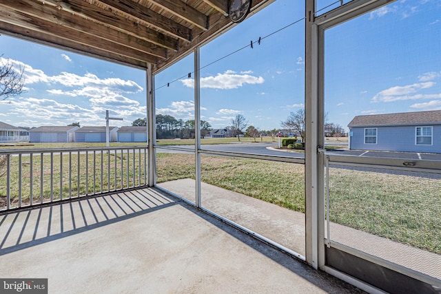 unfurnished sunroom featuring a residential view