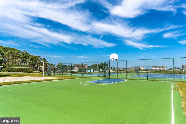 view of basketball court featuring a tennis court, community basketball court, volleyball court, and fence