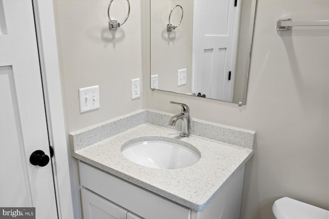 bathroom featuring toilet and vanity