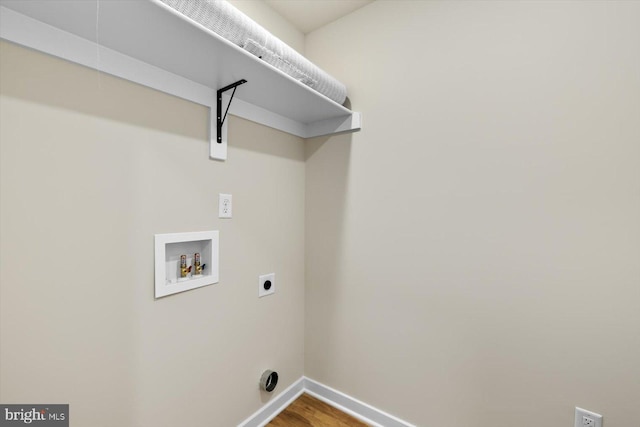 laundry area with hookup for a washing machine, hookup for an electric dryer, wood finished floors, laundry area, and baseboards