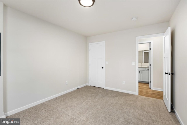 unfurnished bedroom featuring carpet and baseboards