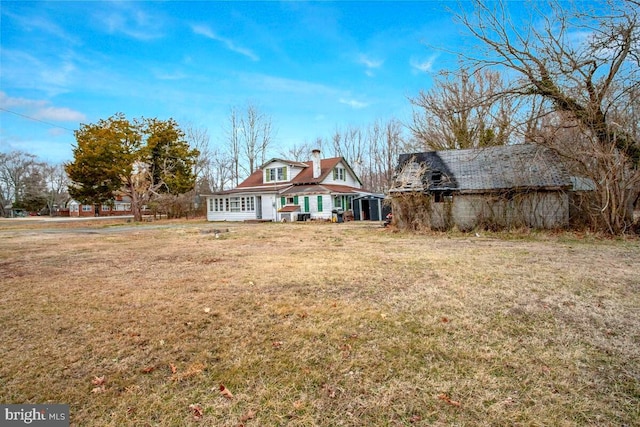 6037 Drum Point Rd, Deale, MD 20751 - rear view of house with a barn, a lawn, a chimney, and an outdoor structure