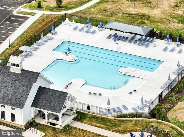 community pool featuring a patio area and fence