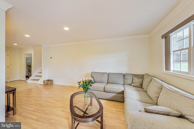 living room featuring stairs, crown molding, baseboards, and light wood-style floors