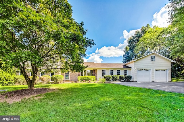 view of front of house with an attached garage, driveway, and a front yard