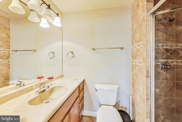 bathroom with visible vents, baseboards, toilet, vanity, and a shower stall