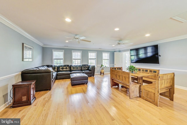 living room featuring recessed lighting, baseboards, crown molding, and light wood finished floors