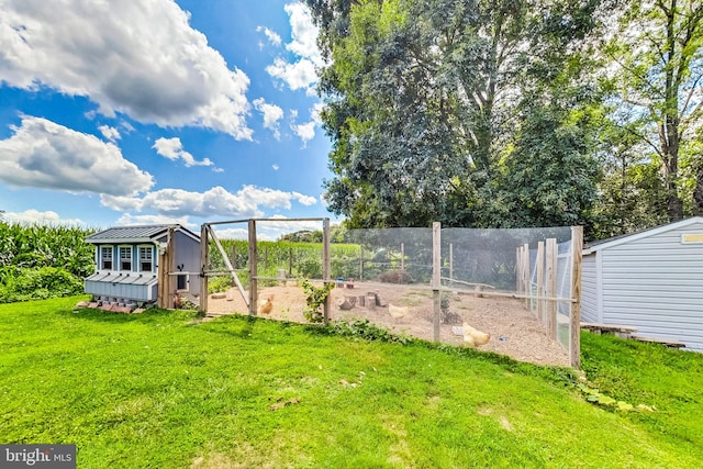 view of yard featuring an outbuilding and exterior structure