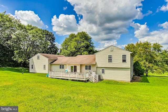 back of house featuring a deck and a yard