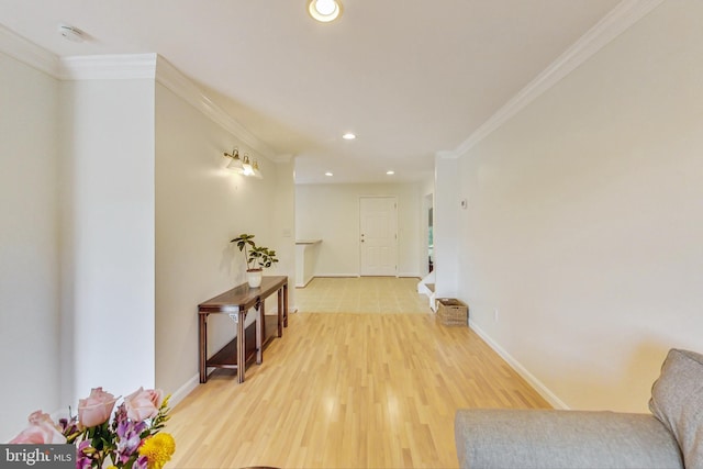 hallway with ornamental molding, recessed lighting, light wood-style flooring, and baseboards