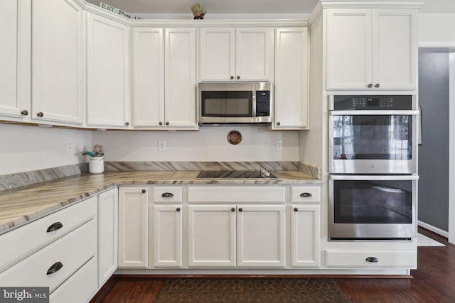 kitchen featuring stainless steel appliances, white cabinets, and light stone countertops