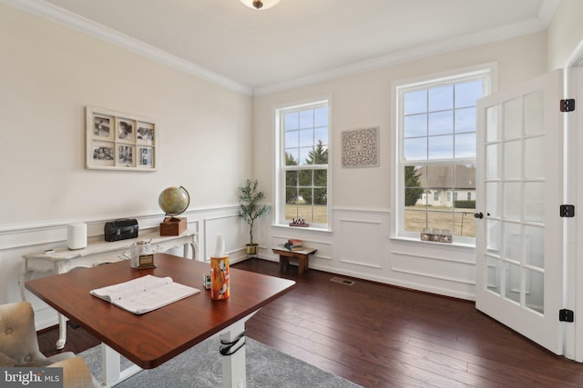 office space with hardwood / wood-style flooring, visible vents, a wainscoted wall, and ornamental molding