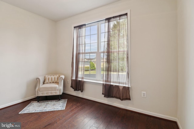 unfurnished room featuring dark wood finished floors and baseboards