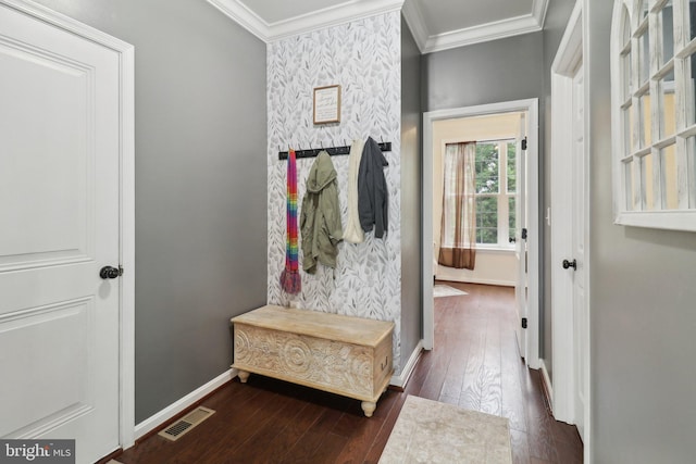 mudroom with dark wood-style flooring, visible vents, ornamental molding, an accent wall, and baseboards